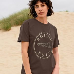 A photo of a woman wearing a chocolate coloured t-shirt