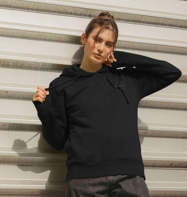 A photo of a woman wearing a black hoodie