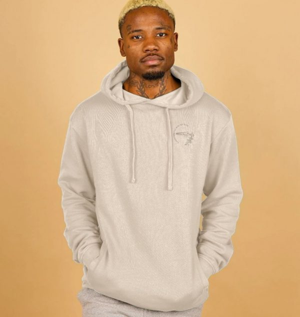 A photo of a man wearing an oat coloured hoodie