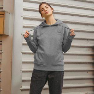 A photo of a woman wearing a light heather coloured hoodie