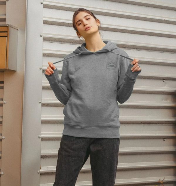 A photo of a woman wearing a light heather coloured hoodie