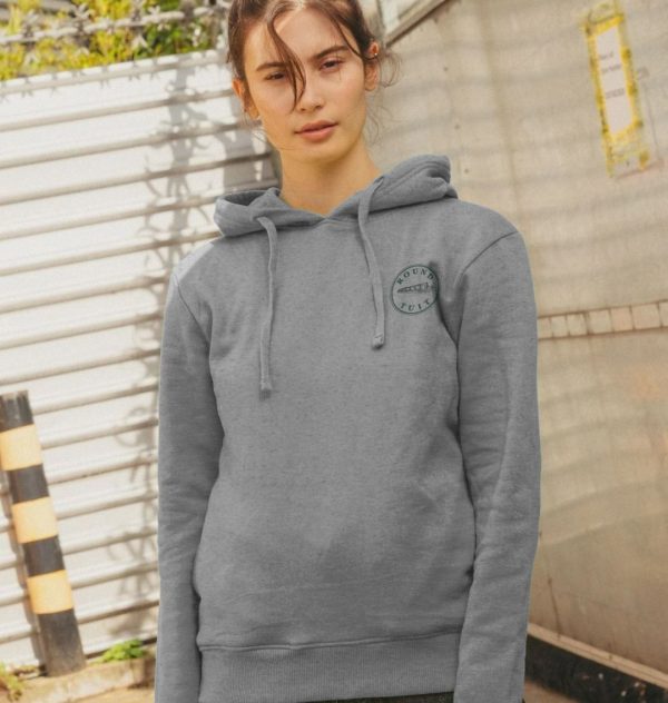 A photo of a woman wearing a light heather coloured hoodie