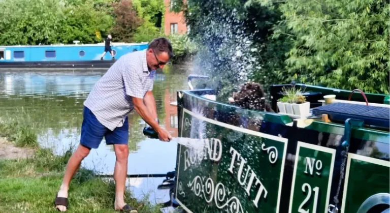 A photo of Narrowboat Rout Tuit being sprayed with champagne
