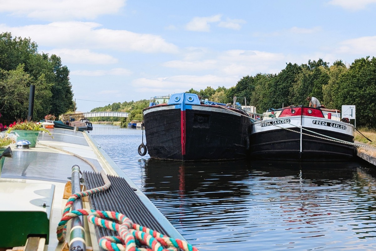 Round Tuit passing two large commercial ships on the Aire & Calder Navigation.