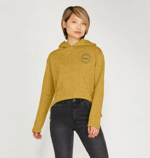 A photo of a woman wearing a sunflower yellow hoodie