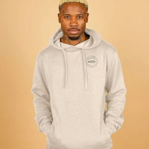 A photo of a man wearing an oat coloured hoodie