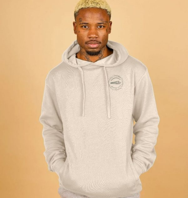 A photo of a man wearing an oat coloured hoodie