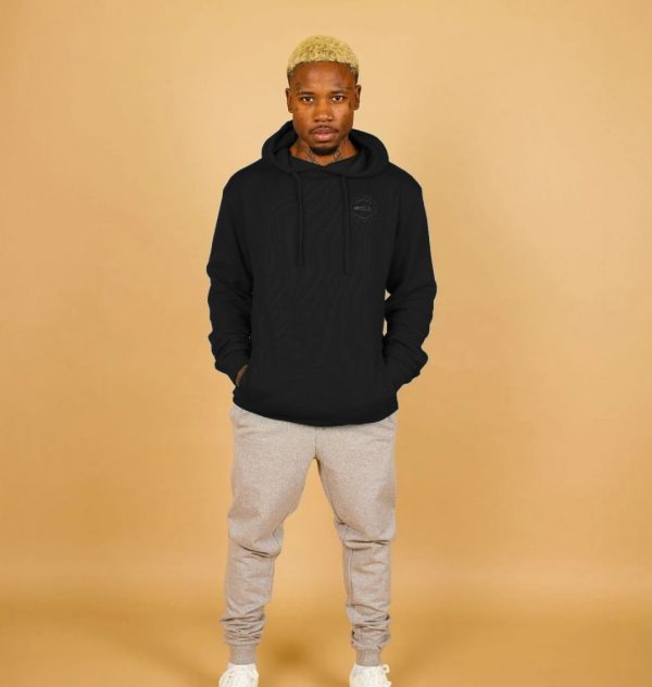 A photo of a man wearing a black hoodie
