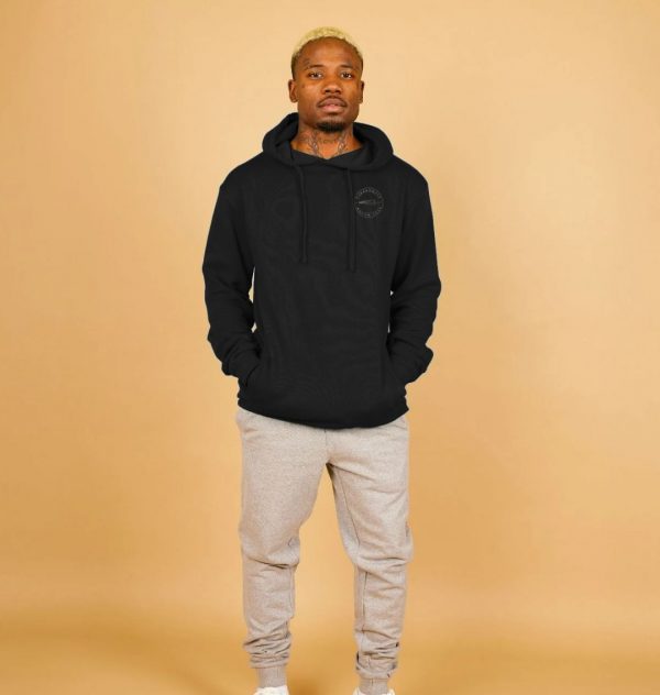 A photo of a man wearing a black hoodie