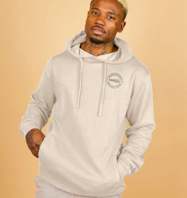 A photo of a man wearing an oat coloured hoodie