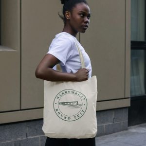 A photo of a woman holding a natural coloured tote bag