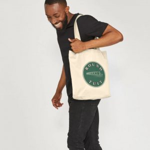 A photo of a man holding a natural coloured tote bag