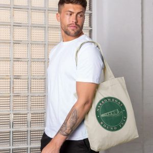 A photo of a man holding a natural coloured tote bag