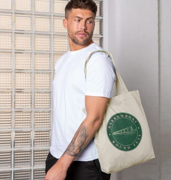 A photo of a man holding a natural coloured tote bag