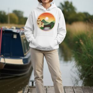 Mock-up of a model wearing the Sunset Kingdom design on a white unisex hoodie, with a canal and narrowboat in the background.
