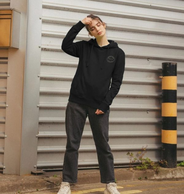 A photo of a woman wearing a black hoodie