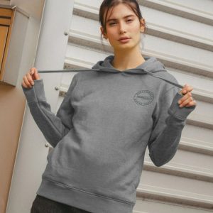 A photo of a woman wearing a light heather coloured hoodie