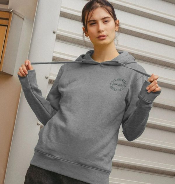 A photo of a woman wearing a light heather coloured hoodie