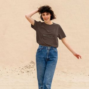 A photo of a woman wearing a chocolate coloured t-shirt
