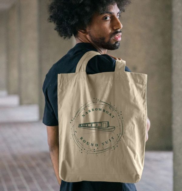 A photo of a man holding a natural coloured tote bag